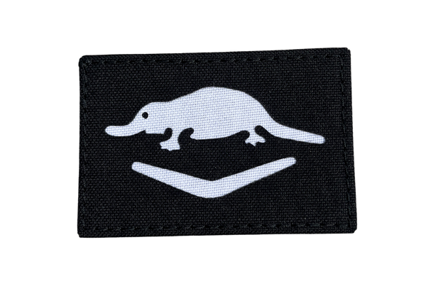 Black patch with white silhouette of a platypus WW2 on a white background